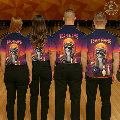 Four people standing in a bowling alley, viewed from behind, wearing matching custom bowling shirts with a raccoon graphic and 'TEAM NAME' text. The shirts feature a sunset gradient background transitioning from purple to orange.