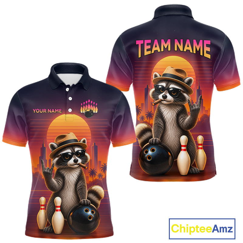 Custom short-sleeve polo shirt shown from the front and back, featuring a cartoon raccoon in a hat holding bowling balls and pins against a sunset skyline. The shirt has a dark-to-orange gradient with 'TEAM NAME' and 'YOUR NAME' text placeholders.
