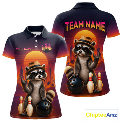 Front and back views of a short-sleeve polo shirt featuring a retro-style raccoon bowling graphic with bowling balls, pins, a sunset, and customizable text areas. The shirt has a dark navy base with orange, pink, and purple gradient accents.