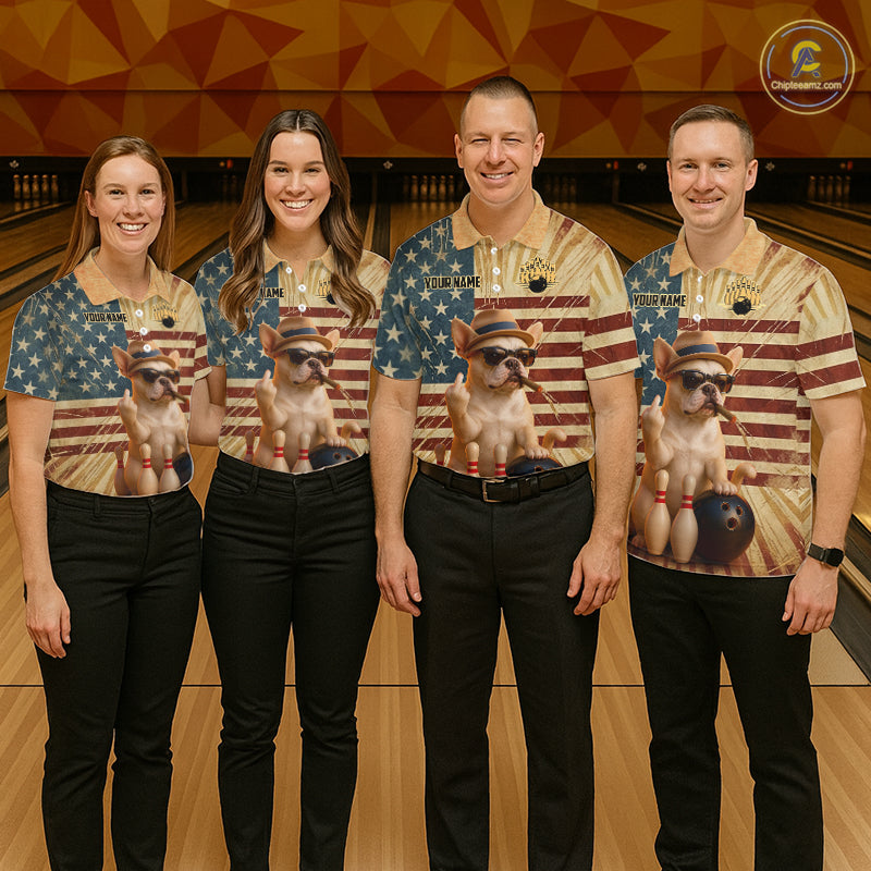 Four people standing in a bowling alley wearing matching bowling shirts with a patriotic American flag design and a printed image of a small dog wearing sunglasses. The shirts have a beige and blue color scheme with red accents.