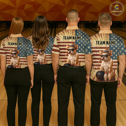 Four people standing in a bowling alley, viewed from behind, wearing matching custom bowling shirts with a patriotic American flag design and a cartoon French Bulldog bowling graphic. The shirts feature the text 'TEAM NAME'.