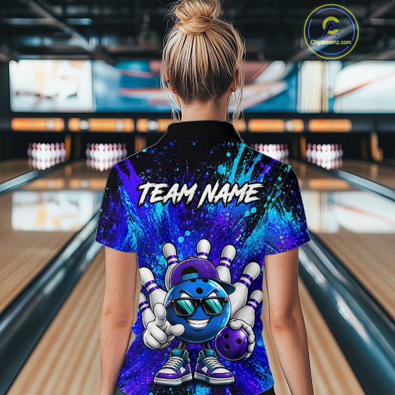 A person standing in a bowling alley wearing a short-sleeve collared shirt with a colorful bowling-themed graphic on the back. The shirt features a blue and purple cosmic pattern, a cartoon bowling ball character, and the text 'TEAM NAME' across the upper back.
