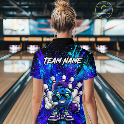 A person standing in a bowling alley wearing a short-sleeve collared shirt with a colorful bowling-themed graphic on the back. The shirt features a blue and purple cosmic pattern, a cartoon bowling ball character, and the text 'TEAM NAME' across the upper back.