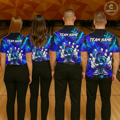 Four people standing in a bowling alley, viewed from the back, wearing matching short-sleeve bowling shirts with a colorful cosmic pinball graphic and 'TEAM NAME' text. The shirts feature a blue, purple, and black galaxy background with a cartoon pinball character holding bowling pins.