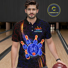 Load image into Gallery viewer, Man standing in a bowling alley wearing a black neon-style bowling polo shirt with a glowing blue cartoon bowling ball mascot, fiery orange pin graphics, and custom name text.