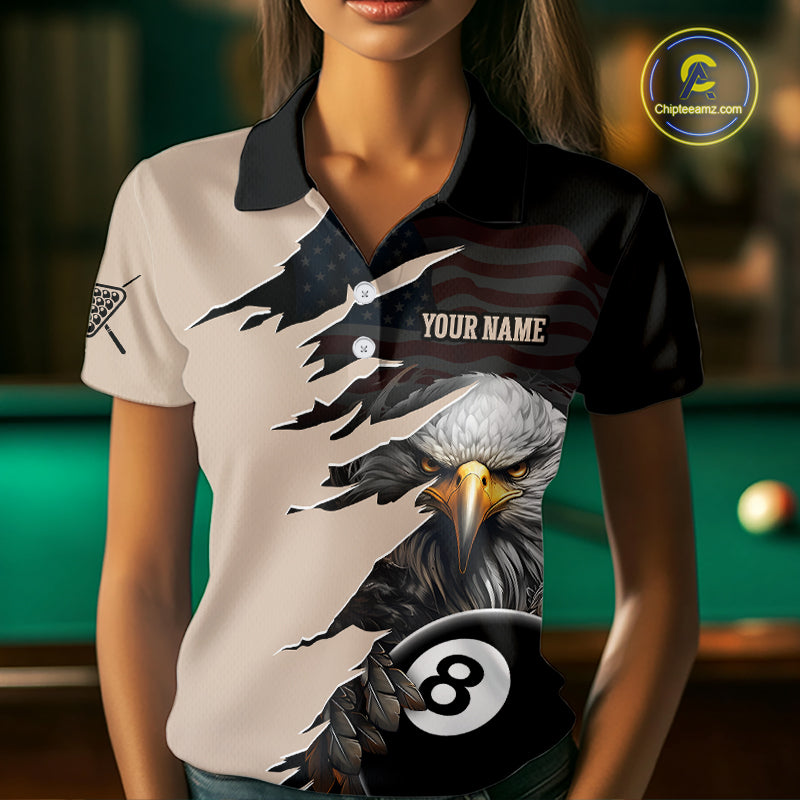 Woman wearing a polo shirt with an eagle and pool ball design in a billiards setting.