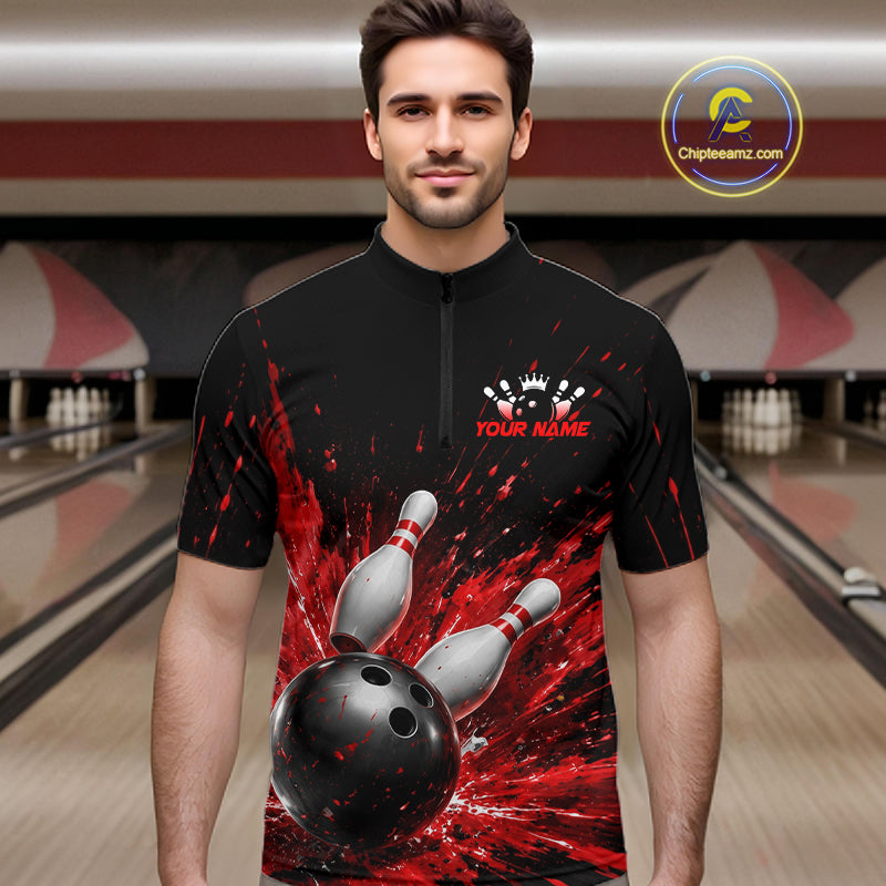 Man wearing a black bowling quarter zip shirt with dramatic red splatter graphics, a large black bowling ball, and flying pins, plus custom player name text.