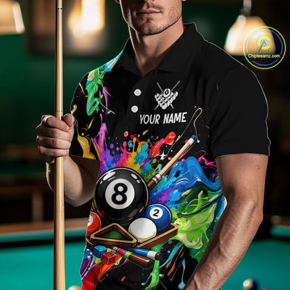 Man holding a pool cue with a colorful shirt featuring billiard ball designs in a pool hall.