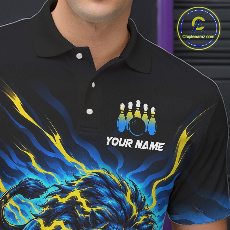 A close-up of a man wearing a black short-sleeve polo shirt with a bowling-themed graphic print. The shirt features a blue and yellow flame design at the bottom, a bowling pins and ball graphic above the customizable white text 'YOUR NAME'.