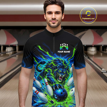 A man wearing a black short-sleeve quarter-zip bowling jersey with a vibrant blue and green graphic of a roaring lion and bowling pins, set against a bowling alley background.