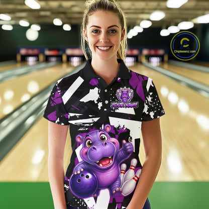 Woman wearing of a black, white, and purple bowling polo shirt featuring a cheerful purple hippo holding a bowling ball, with custom player name text.