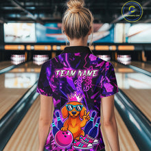 Load image into Gallery viewer, Woman wearing a black and purple bowling quarter zip shirt featuring a cartoon dachshund wearing sunglasses and a crown, holding a pink bowling ball, with custom team name text.