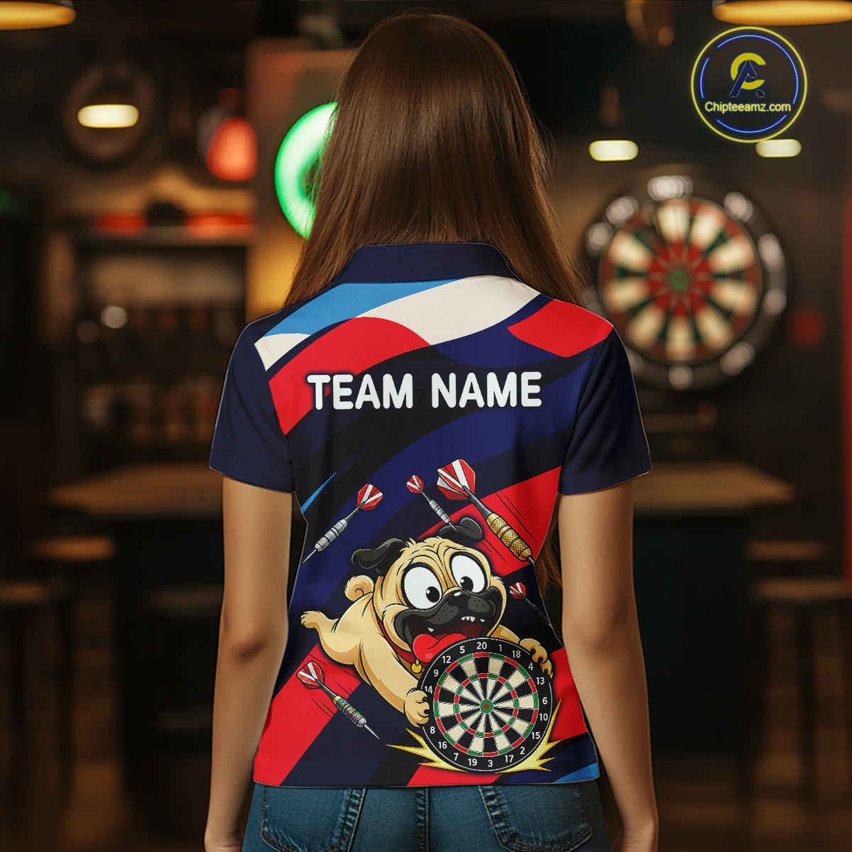 Person wearing a navy, red, and white darts polo featuring a cartoon pug holding a dartboard, flying darts, and custom team text.