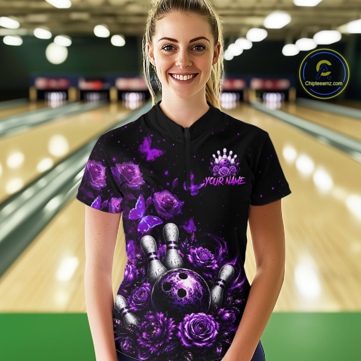 Women’s purple rose butterfly bowling quarter zip shirt, front view on female model in bowling lane 