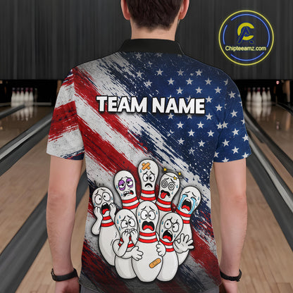 A person standing in a bowling alley wearing a short-sleeve collared shirt from the back. The shirt features a distressed American flag design in red, white, and blue, with the text 'TEAM NAME' across the upper back and a cartoon group of crying bowling pins near the lower back.