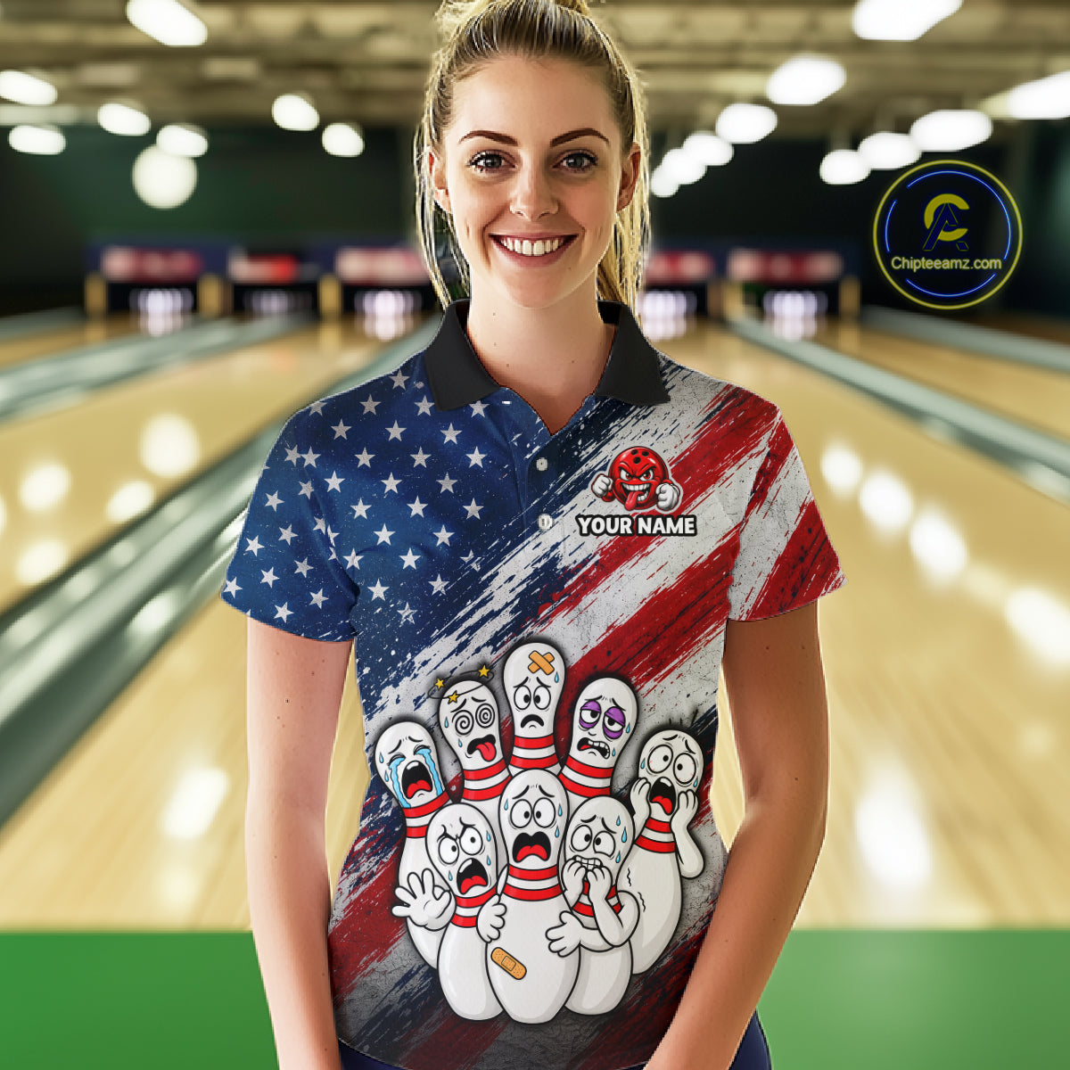 A woman stands in a bowling alley wearing a custom bowling-themed polo shirt with a distressed American flag design and cartoon bowling pins. The shirt features a black collar and a customizable name patch on the chest.