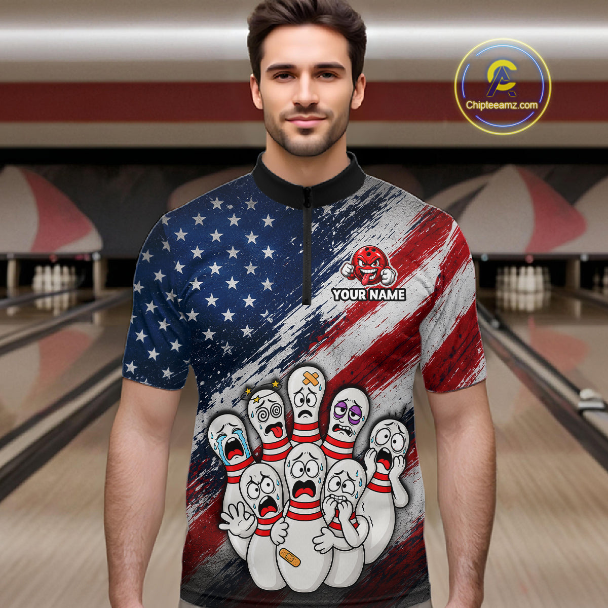 A man wearing a short-sleeve quarter-zip bowling-themed shirt with a distressed American flag design and cartoon bowling pins on the front, standing in a bowling alley. 
