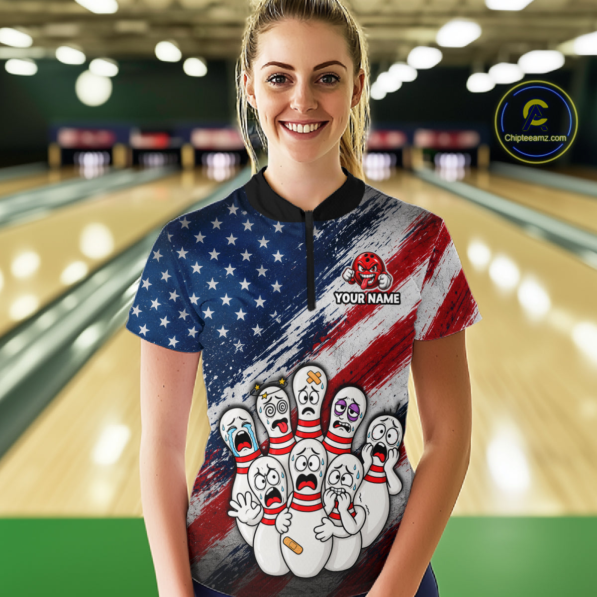 A woman stands in a bowling alley wearing a short-sleeve collared bowling shirt with a patriotic American flag design, cartoon bowling pins, and a customizable name patch.