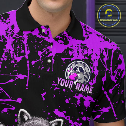 A close-up of a man wearing a black and bright purple polo shirt with a splatter print, a custom raccoon logo, and the text 'YOUR NAME'.
