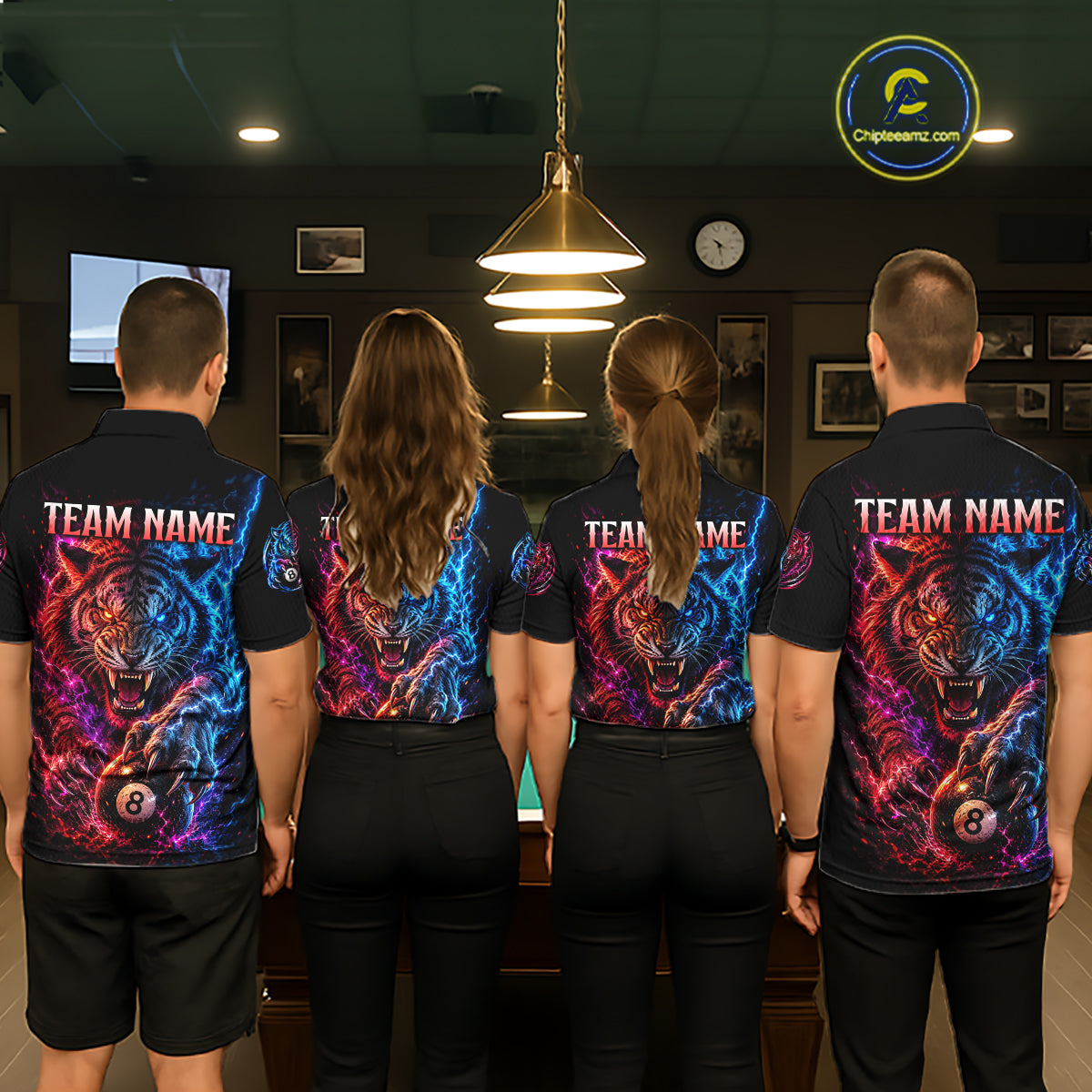 Four people wearing matching shirts with a team name and colorful tiger design in a room.