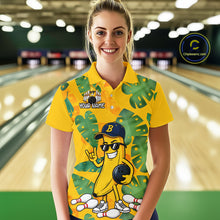 Load image into Gallery viewer, Woman in a bowling alley wearing a bright yellow tropical polo shirt with green leaf patterns, custom name text, and a smiling banana mascot holding a bowling ball.