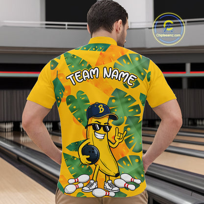 Man in a bowling alley wearing a bright yellow tropical quarter zip shirt with green leaf patterns, custom team name text, and a smiling banana mascot holding a bowling ball.