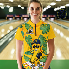 Load image into Gallery viewer, Woman in a bowling alley wearing a bright yellow tropical quarter zip shirt with green leaf patterns, custom team name text, and a smiling banana mascot holding a bowling ball.