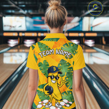Load image into Gallery viewer, Woman in a bowling alley wearing a bright yellow tropical quarter zip shirt with green leaf patterns, custom name text, and a smiling banana mascot holding a bowling ball.