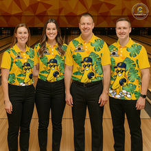Load image into Gallery viewer, Four people wearing matching yellow bowling shirts with a banana character on a bowling alley.