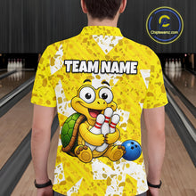 Load image into Gallery viewer, Man wearing a yellow bowling-themed shirt with a cartoon turtle holding a bowling ball and pins in a bowling alley.