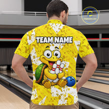 Load image into Gallery viewer, Man wearing a yellow bowling-themed shirt with a cartoon turtle holding a bowling ball in a bowling alley.