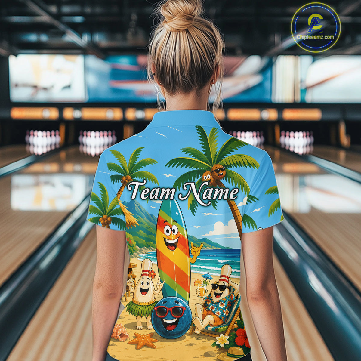 Woman wearing a sky blue bowling polo with a tropical beach scene, smiling bowling ball and pins, colorful surfboard, palm trees, and personalized team name 