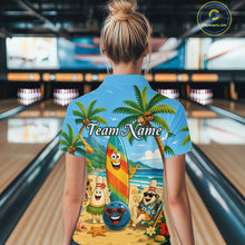 Load image into Gallery viewer, Woman wearing a sky blue bowling polo with a tropical beach scene, smiling bowling ball and pins, colorful surfboard, palm trees, and personalized team name 