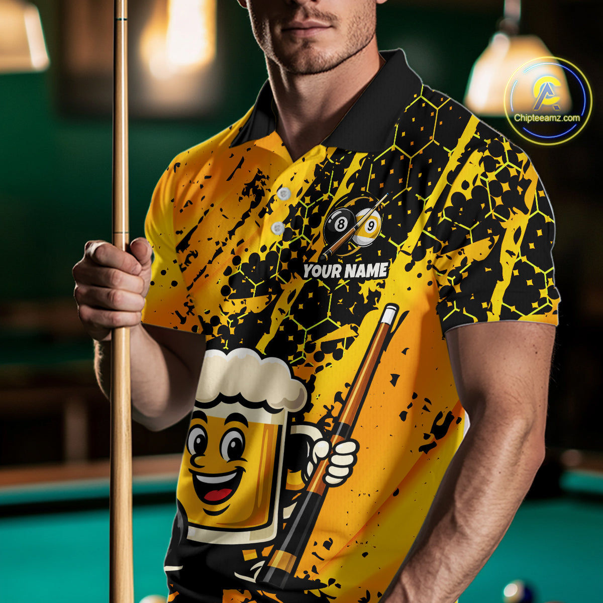 Man wearing a yellow funny beer billiard shirt with a pool cue, standing in front of a pool table.