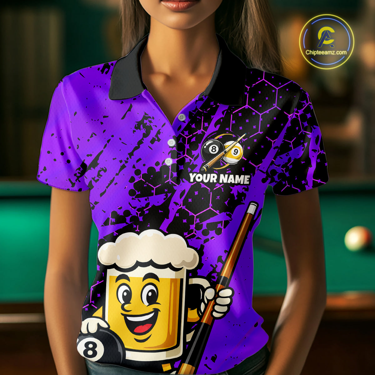 Woman wearing a bright purple billiards polo with black splatter graphics, custom “YOUR NAME” text, and a smiling beer mug mascot holding a pool cue.
