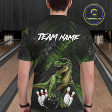 Load image into Gallery viewer, Man wearing bowling polo shirt featuring a dinosaur standing among bowling pins and ball artwork on black green textured background.