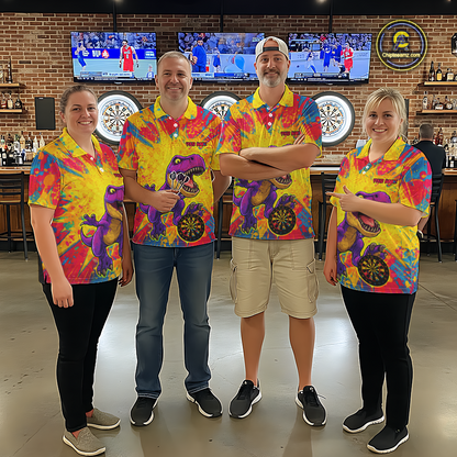 Four people wearing darts polo shirt featuring a purple dinosaur holding a dartboard within a bright colorful paint splatter background.