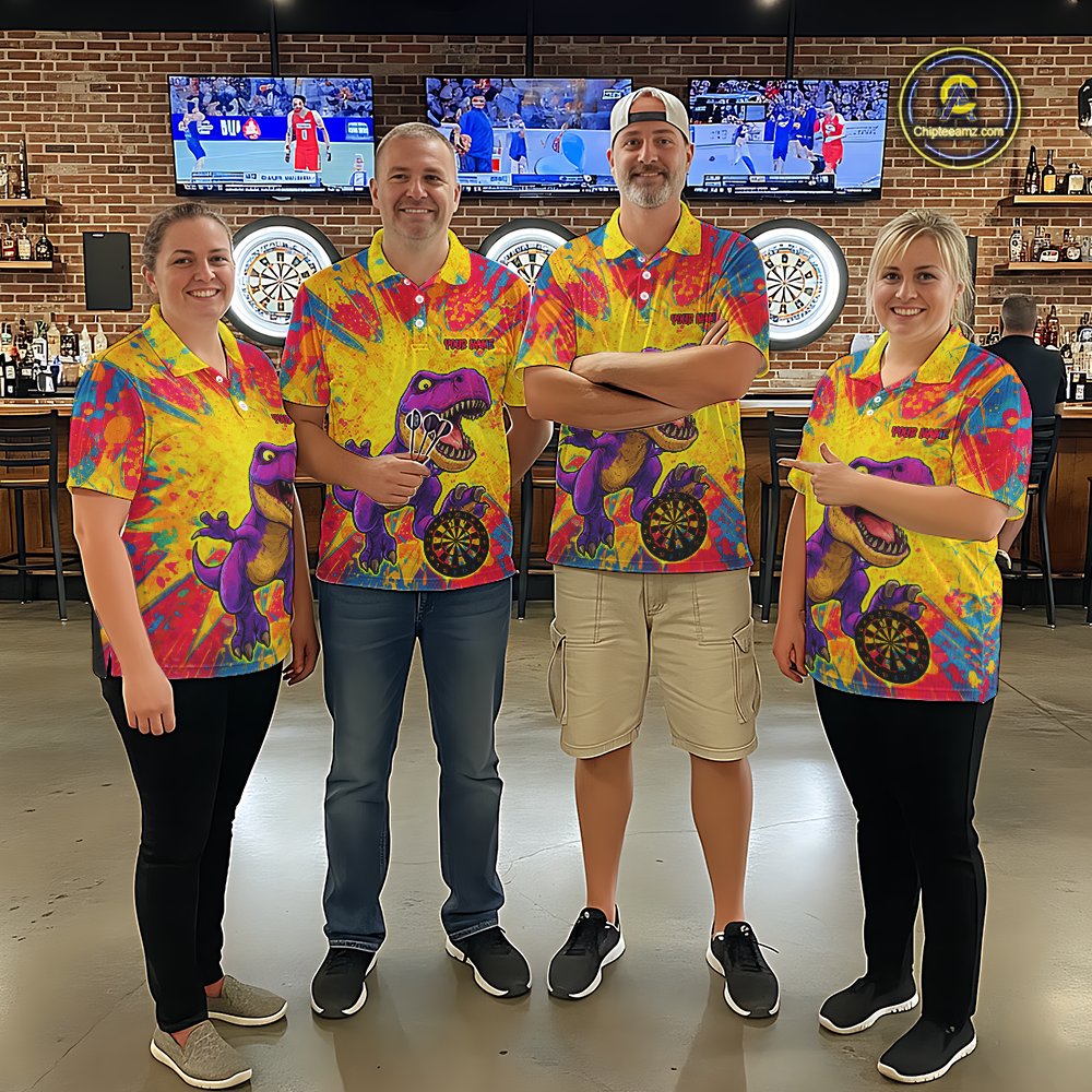 Four people wearing darts polo shirt featuring a purple dinosaur holding a dartboard within a bright colorful paint splatter background.