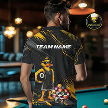 Load image into Gallery viewer, Men wearing billiards polo shirt featuring a duck holding an eight ball with colorful pool balls arranged on a black yellow background.