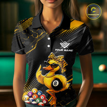 Load image into Gallery viewer, Women wearing billiards polo shirt featuring a duck holding an eight ball with pool balls arranged across a black yellow background.