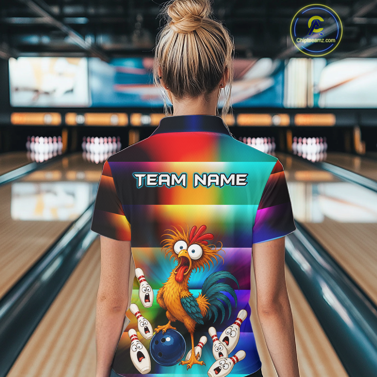 Woman wearing a colorful bowling polo featuring a shocked rooster chicken, blue bowling ball, surprised pins, and custom team name text.
