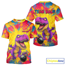 Load image into Gallery viewer, Colorful t-shirt with a dinosaur design and 'Team Name' text on a white background.