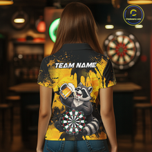 Load image into Gallery viewer, Person wearing a black and yellow darts polo featuring a raccoon drinking beer, dartboard graphics, and custom team and player name text.