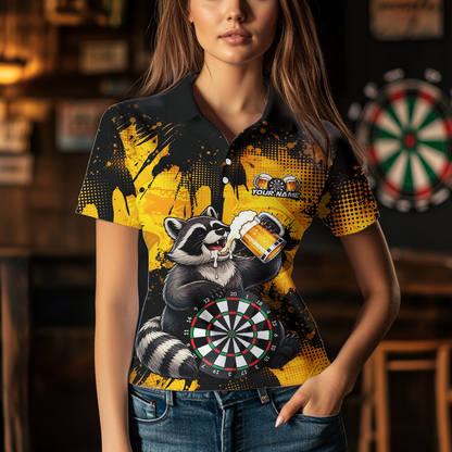 Person wearing a black and yellow darts polo featuring a raccoon drinking beer, dartboard graphics, and custom team and player name text.