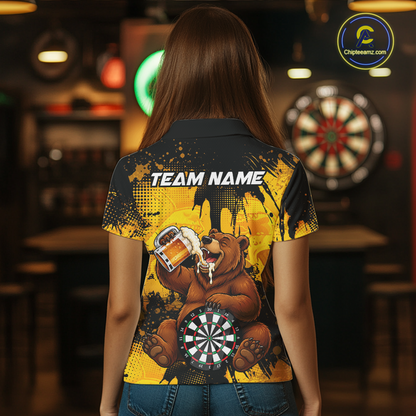 Person wearing a black and yellow darts polo featuring a bear drinking beer, dartboard graphics, and custom team and player name text.