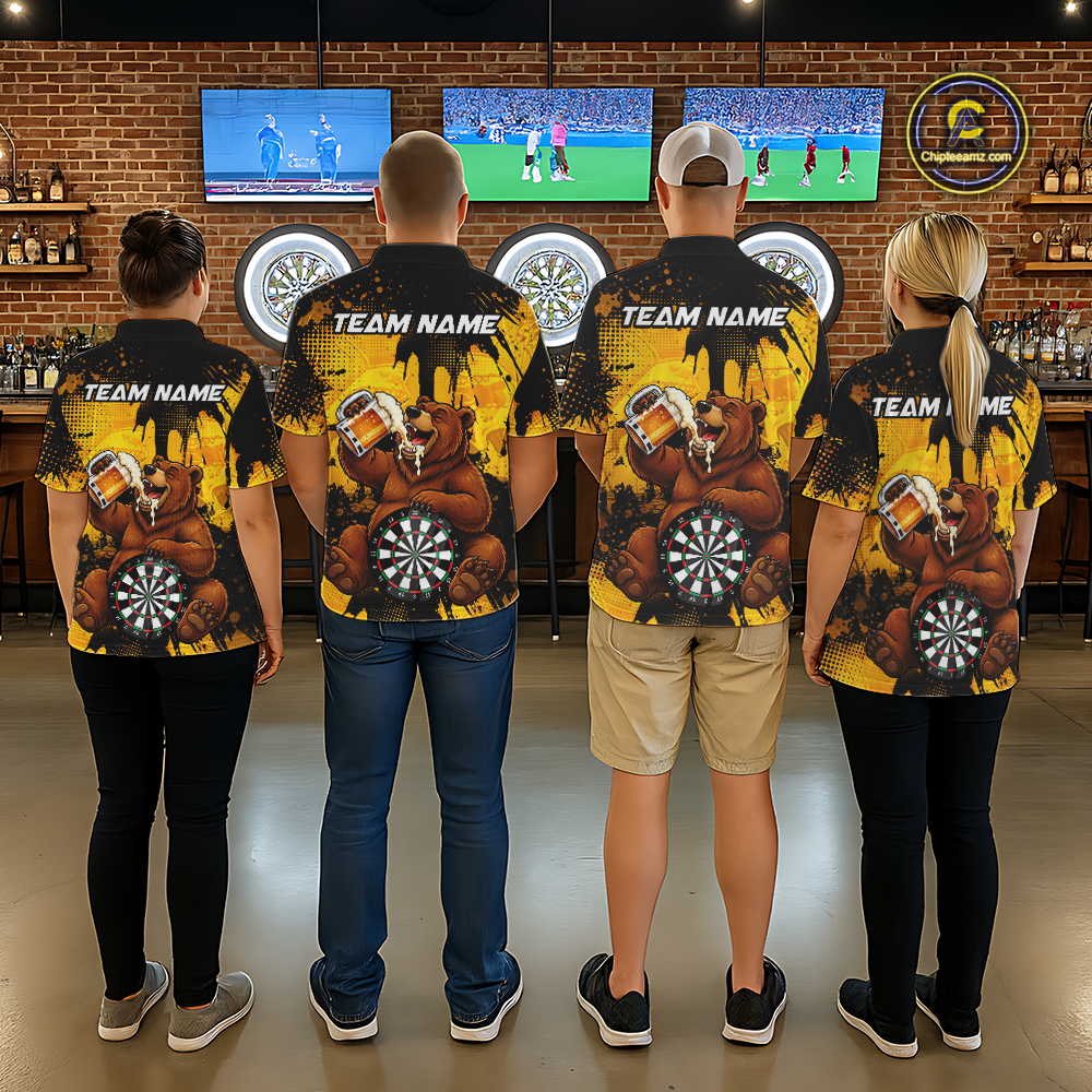 Four people wearing black and yellow darts polo featuring a bear drinking beer, dartboard graphics, and custom team and player name text.
