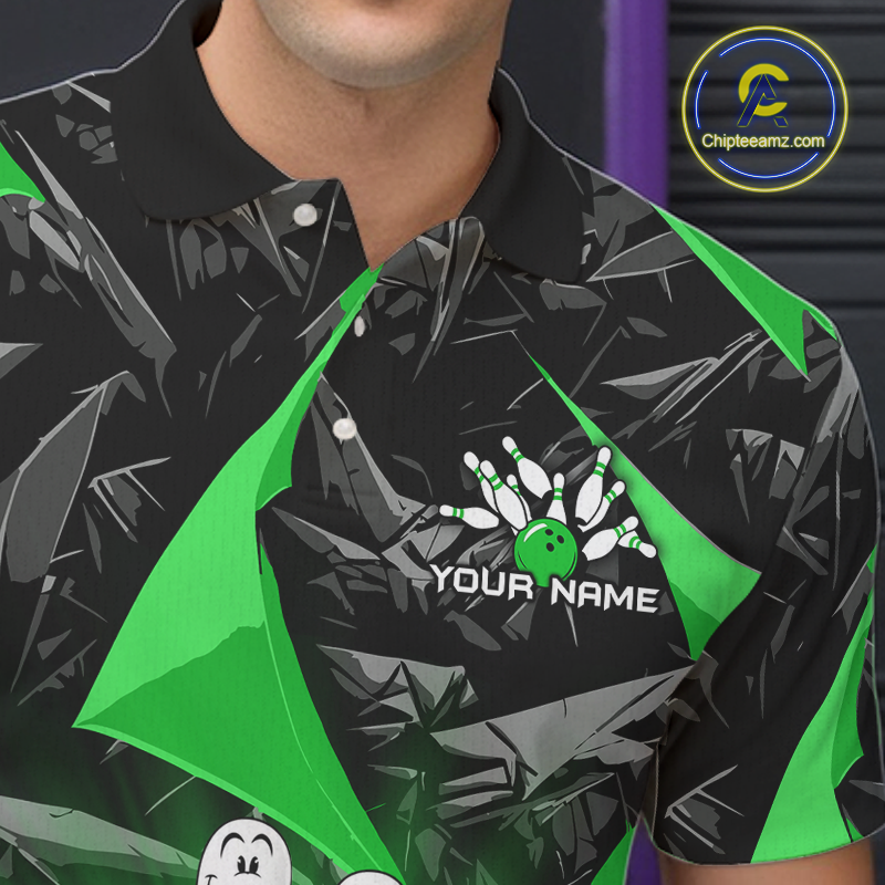 A close-up of a person wearing a short-sleeve polo shirt with a black and gray tropical leaf print, bright green geometric accents, and a bowling-themed graphic with the text 'YOUR NAME' on the chest.