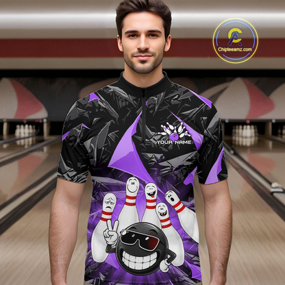 A man wearing a custom bowling-themed short-sleeve t-shirt with a black and purple geometric pattern and cartoon bowling pins and ball graphic. The background shows a blurred bowling alley.