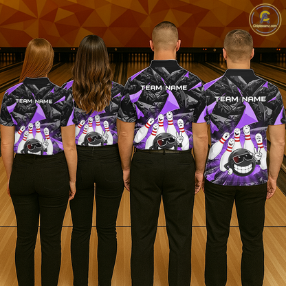 Four people standing with their backs to the camera in a bowling alley, wearing matching purple and black bowling shirts with bowling pin and cartoon character graphics, paired with black pants.