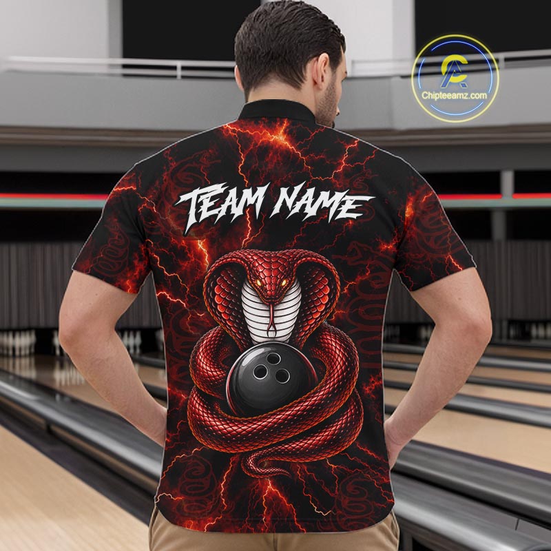A man viewed from behind wearing a black short-sleeve bowling shirt with a red and black snake graphic coiled around a bowling ball and the text 'TEAM NAME' across the upper back. Bowling lanes are visible in the background, and a 'Chipteeamz.